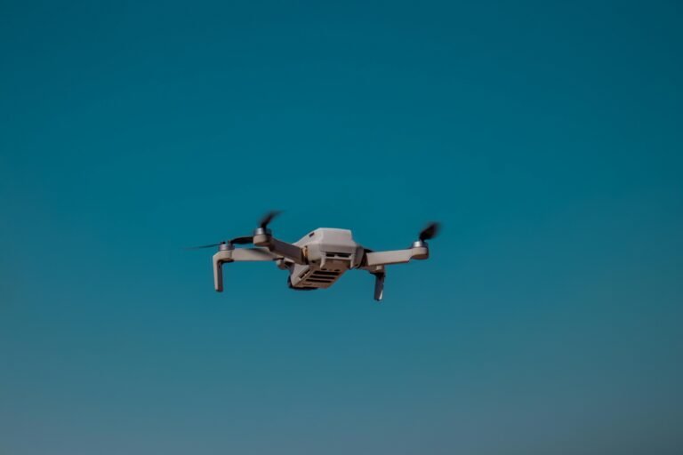 Aerial drone flying in the open sky on a clear day, showcasing modern technology.