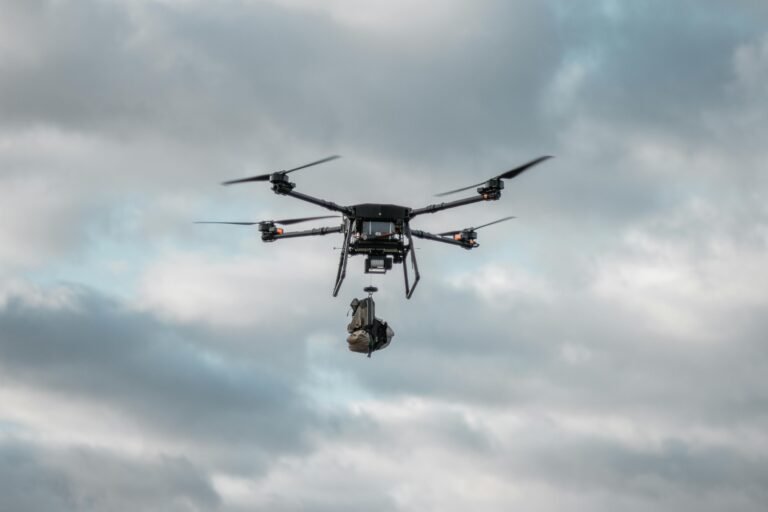 Powerful drone in flight with cargo against dramatic cloudy background.