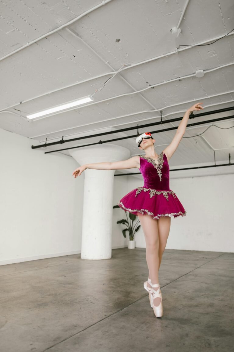 A ballerina in a vibrant outfit dances gracefully wearing a VR headset in a studio setting.