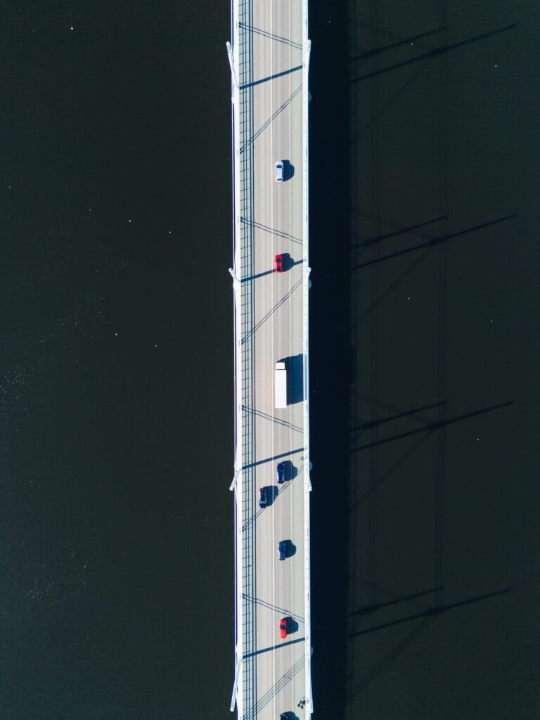 Top-down drone shot of a bridge over water in Jönköping, Sweden showing vehicles in transit.
