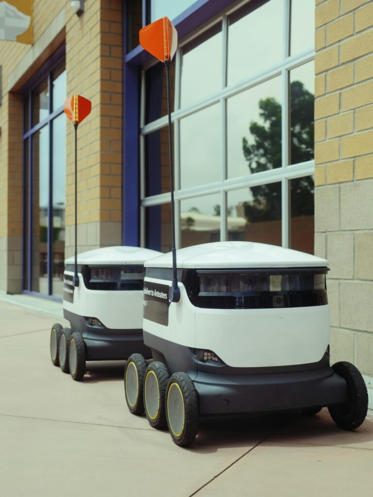 Futuristic food delivery robots operating autonomously outdoors.