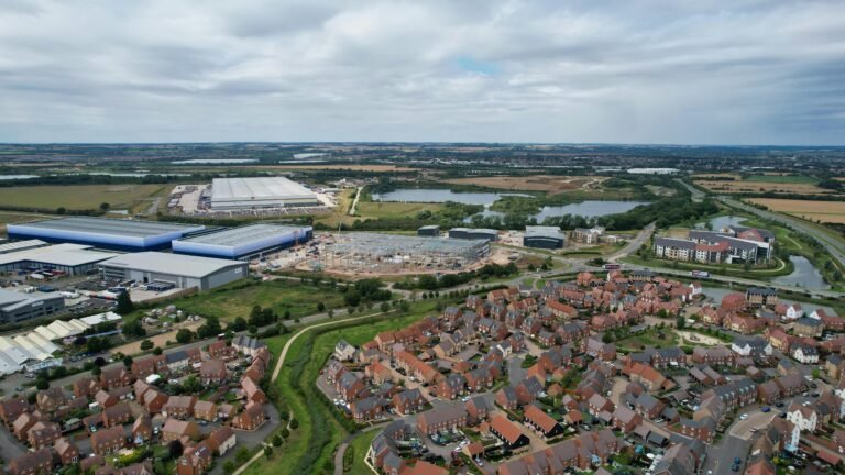 Aerial photograph of houses and industrial buildings in Bedford, England, on a cloudy day.